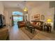 Inviting living room featuring vaulted ceilings, stylish décor, and sliding doors to the outdoor patio at 2609 Summer Creek Dr, Kissimmee, FL 34747