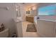 Bathroom featuring a tiled floor, double sink vanity, soaking tub, and frameless glass shower enclosure at 2609 Summer Creek Dr, Kissimmee, FL 34747