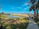 Enjoy the view of the pond from the bench at 2609 Summer Creek Dr, Kissimmee, FL 34747