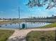 A view of the serene pond with palm trees in the distance at 2609 Summer Creek Dr, Kissimmee, FL 34747