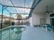 Screened-in pool and patio area with lounge chairs and patio furniture at 2609 Summer Creek Dr, Kissimmee, FL 34747