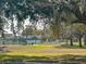 Community tennis court surrounded by mature trees at 2609 Summer Creek Dr, Kissimmee, FL 34747