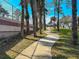 Winding community walkway alongside mature shade trees at 2609 Summer Creek Dr, Kissimmee, FL 34747