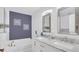 Bright bathroom featuring a double vanity with marble countertop and modern fixtures at 2783 Trommel Way, Sanford, FL 32771