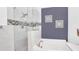 Bathroom featuring glass shower with tile accents and a soaking tub with stylish fixtures at 2783 Trommel Way, Sanford, FL 32771