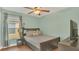Comfortable bedroom featuring a cozy bed and a window with curtains at 2783 Trommel Way, Sanford, FL 32771