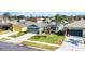 Well-maintained home with a green lawn, mature tree, and two-car garage at 2783 Trommel Way, Sanford, FL 32771