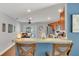 Stylish kitchen with modern appliances, cherry wood cabinets, and a breakfast bar overlooking the dining area at 2783 Trommel Way, Sanford, FL 32771