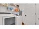 Convenient laundry room with washer, dryer, and shelving for storage at 2783 Trommel Way, Sanford, FL 32771