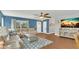 Bright and inviting living room featuring hardwood floors, comfortable seating, and a large window at 2783 Trommel Way, Sanford, FL 32771