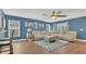 Cozy living room with hardwood floors, a comfortable seating arrangement, and abundant natural light at 2783 Trommel Way, Sanford, FL 32771