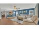 Open-concept living space showcasing hardwood floors, a comfortable seating area, and seamless flow to the kitchen at 2783 Trommel Way, Sanford, FL 32771