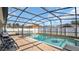 Relaxing screened-in pool area with comfortable seating, perfect for enjoying sunny days and outdoor entertaining at 2783 Trommel Way, Sanford, FL 32771