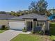 One-story house with a driveway and a well-maintained lawn at 2896 Lingo Ln, Orlando, FL 32822