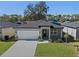 Single-story home with a dark gray roof and a spacious front yard at 2896 Lingo Ln, Orlando, FL 32822