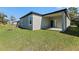 Newly constructed home with covered patio and grassy backyard at 2896 Lingo Ln, Orlando, FL 32822