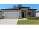 Newly built home with a two-car garage and a modern facade at 2896 Lingo Ln, Orlando, FL 32822