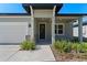 Covered front porch with stone accents and lush landscaping at 2896 Lingo Ln, Orlando, FL 32822