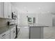 Open concept kitchen with island and view into adjacent living space at 2896 Lingo Ln, Orlando, FL 32822