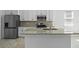 Modern kitchen with stainless steel refrigerator and white cabinets at 2896 Lingo Ln, Orlando, FL 32822