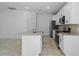 Modern kitchen with white cabinets, granite counters, and stainless steel appliances at 2896 Lingo Ln, Orlando, FL 32822