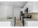 Modern kitchen with white cabinets, granite countertops, and stainless steel appliances at 2896 Lingo Ln, Orlando, FL 32822
