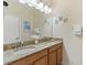 Bathroom with granite countertop, double sinks, and mirror at 3071 Beach Palm Ave, Kissimmee, FL 34747