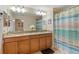 Double vanity bathroom with granite countertop and shower at 3071 Beach Palm Ave, Kissimmee, FL 34747