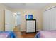 Bedroom with dresser, TV, and access to upper floor at 3071 Beach Palm Ave, Kissimmee, FL 34747