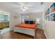 Main bedroom with king bed, ceiling fan, and en-suite bathroom at 3071 Beach Palm Ave, Kissimmee, FL 34747