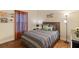 Bedroom with striped bedding and wood flooring at 3071 Beach Palm Ave, Kissimmee, FL 34747
