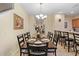 Formal dining room with a long table and chandelier at 3071 Beach Palm Ave, Kissimmee, FL 34747