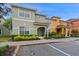 Exterior view of a two-story townhome with landscaping at 3071 Beach Palm Ave, Kissimmee, FL 34747