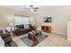 Living room with tiled floors, brown couches, and a coffee table at 3071 Beach Palm Ave, Kissimmee, FL 34747