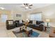 Living room with tiled floors, brown couches, and a coffee table at 3071 Beach Palm Ave, Kissimmee, FL 34747