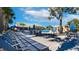 Resort-style pool with lounge chairs, tables, and umbrellas at 3071 Beach Palm Ave, Kissimmee, FL 34747