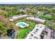This aerial view of the community shows lush landscaping and well-maintained condo buildings and a pool at 3104 Harrison Ave # 11, Orlando, FL 32804
