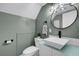 Modern bathroom featuring a sleek vanity, round mirror, and stylish design at 3104 Harrison Ave # 11, Orlando, FL 32804