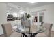 Stylish dining area with glass table and bright view into kitchen at 3104 Harrison Ave # 11, Orlando, FL 32804