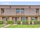 Charming townhouse featuring manicured landscaping, covered entrance and shingled facade at 3104 Harrison Ave # 11, Orlando, FL 32804