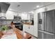 Modern kitchen with white cabinets, stainless steel appliances, and wood countertops at 3104 Harrison Ave # 11, Orlando, FL 32804
