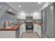 Modern kitchen with stainless steel appliances, white cabinets and lots of counter space at 3104 Harrison Ave # 11, Orlando, FL 32804