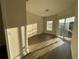 Well-lit bedroom showcasing wood-look floors and access to balcony at 3621 Conroy Rd # 730, Orlando, FL 32839