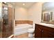 Bathroom features a shower, garden tub, and dark wood vanity at 4220 Messina Dr, Lake Mary, FL 32746