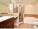 Bathroom with shower, bathtub, granite vanity, and tile flooring at 4220 Messina Dr, Lake Mary, FL 32746