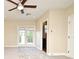 Spacious bedroom with ceiling fan, private balcony access, and carpet flooring at 4220 Messina Dr, Lake Mary, FL 32746