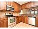 Modern kitchen features stainless steel appliances and wood cabinets at 4220 Messina Dr, Lake Mary, FL 32746