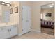 Bathroom with vanity, linen closet, and bedroom view at 426 Vista Loop, Davenport, FL 33897