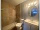 Tiled bathroom with stand up shower, toilet, and vanity at 4709 Almond Willow Dr, Orlando, FL 32808