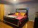 The bedroom offers a queen sized bed, a nightstand on either side, and hardwood floors at 4709 Almond Willow Dr, Orlando, FL 32808